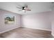This bedroom has a window, ceiling fan, and wood-look flooring at 10140 Bridlewood Ave, Orlando, FL 32825