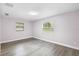A simple bedroom with wood-look floors and a large window at 10140 Bridlewood Ave, Orlando, FL 32825