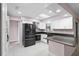 Bright kitchen with white cabinets, stainless appliances, and skylight at 10140 Bridlewood Ave, Orlando, FL 32825
