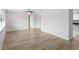 Bright, airy living room with wood-look floors and access to the kitchen at 10140 Bridlewood Ave, Orlando, FL 32825
