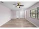 Spacious living room featuring wood-look floors, a ceiling fan, and multiple doorways at 10140 Bridlewood Ave, Orlando, FL 32825
