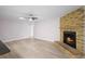 Spacious living room featuring brick fireplace, wood floors, and ample natural light at 10140 Bridlewood Ave, Orlando, FL 32825
