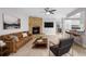 Cozy living room features a brick fireplace, modern ceiling fan, and stylish decor at 10140 Bridlewood Ave, Orlando, FL 32825
