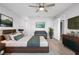 Bright main bedroom features a large bed, modern decor, and neutral tones at 10140 Bridlewood Ave, Orlando, FL 32825