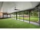 A screened-in patio featuring an above-ground pool and artificial turf at 10140 Bridlewood Ave, Orlando, FL 32825