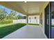 Covered back patio overlooks a spacious yard, perfect for entertaining at 1018 Boxelder Ave, Minneola, FL 34715
