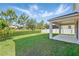 Beautifully landscaped back yard with a covered patio and privacy fence at 1018 Boxelder Ave, Minneola, FL 34715