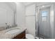 Clean bathroom featuring a glass-enclosed shower and granite vanity top at 1018 Boxelder Ave, Minneola, FL 34715