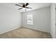 Bedroom with a ceiling fan, a window and neutral carpet at 1018 Boxelder Ave, Minneola, FL 34715