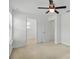 Bright bedroom features neutral carpet, white walls, and a modern ceiling fan at 1018 Boxelder Ave, Minneola, FL 34715