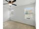 Bedroom with a ceiling fan, two windows and neutral carpet at 1018 Boxelder Ave, Minneola, FL 34715