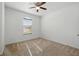 Bright, vacant bedroom with neutral carpet, window, and base molding at 1018 Boxelder Ave, Minneola, FL 34715