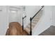 Inviting home foyer featuring wood floors, a staircase, and a view of the front door at 1018 Boxelder Ave, Minneola, FL 34715