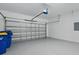 Spacious two-car garage with painted floors and modern, paneled doors at 1018 Boxelder Ave, Minneola, FL 34715