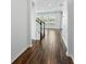 Bright hallway with wood floors leading to a naturally lit living area with an staircase at 1018 Boxelder Ave, Minneola, FL 34715