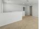 Spacious hallway with neutral carpet, white walls, and natural light, offering a bright and inviting transition space at 1018 Boxelder Ave, Minneola, FL 34715