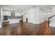 Modern kitchen with island, stainless steel appliances, and white cabinets, open to the living area at 1018 Boxelder Ave, Minneola, FL 34715