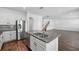Open-concept kitchen boasts stainless steel appliances and granite countertops, perfect for entertaining at 1018 Boxelder Ave, Minneola, FL 34715