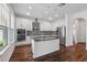 Contemporary kitchen featuring an island, white cabinetry, stainless appliances, and recessed lighting at 1018 Boxelder Ave, Minneola, FL 34715