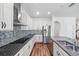 Modern kitchen featuring stainless steel appliances, granite counters, and stylish backsplash at 1018 Boxelder Ave, Minneola, FL 34715