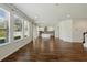 Spacious living area with wood-look flooring and lots of natural light leading into the kitchen at 1018 Boxelder Ave, Minneola, FL 34715