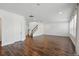 Open living space features wood-look tile, a staircase, and neutral walls for a bright atmosphere at 1018 Boxelder Ave, Minneola, FL 34715