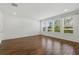 Spacious open living room features wood-look flooring, recessed lighting, and many windows at 1018 Boxelder Ave, Minneola, FL 34715