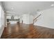 Open-concept living area with wood-look floors, stairs, and modern kitchen in a bright space at 1018 Boxelder Ave, Minneola, FL 34715