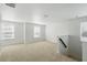 Upstairs loft features neutral carpet, white walls, and natural lighting at 1018 Boxelder Ave, Minneola, FL 34715