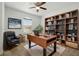 Well-appointed office featuring a large desk, bookshelves, and a comfortable seating area at 1018 Boxelder Ave, Minneola, FL 34715
