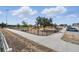 Fenced playground with swings, slides, spring riders, and a walking path provides a safe and enjoyable recreation area for residents at 1018 Boxelder Ave, Minneola, FL 34715