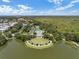 Scenic aerial view of a community with a lake, pool, tennis courts, and lush green surroundings at 1106 Celebration Ave, Celebration, FL 34747