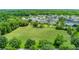 Aerial view shows a well-manicured community green space surrounded by houses and lush trees at 1106 Celebration Ave, Celebration, FL 34747