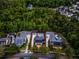An aerial view of a property with a screened in pool and lush trees surrounding it at 1106 Celebration Ave, Celebration, FL 34747