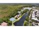 Aerial view showcases tennis courts and a river, alongside residential buildings surrounded by lush greenery at 1106 Celebration Ave, Celebration, FL 34747