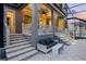 Cozy back porch with comfortable seating, illuminated steps and patio and in-ground pool at 1106 Celebration Ave, Celebration, FL 34747