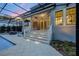A covered back porch features recessed lighting, and outdoor seating, next to the in-ground pool at 1106 Celebration Ave, Celebration, FL 34747