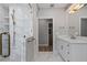 Bright bathroom boasting a marble shower, vanity, and bronze hardware at 1106 Celebration Ave, Celebration, FL 34747