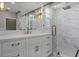 Luxurious bathroom featuring double vanities, a marble shower, and designer lighting at 1106 Celebration Ave, Celebration, FL 34747