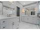 Elegant bathroom with double vanities, marble floors, and a glass-enclosed shower at 1106 Celebration Ave, Celebration, FL 34747