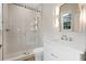 Bright bathroom features a glass-enclosed shower, white vanity with sink, a lighted mirror, and tile floors at 1106 Celebration Ave, Celebration, FL 34747