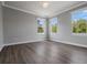 Cozy bedroom with wood-look floors and natural light from large windows at 1106 Celebration Ave, Celebration, FL 34747