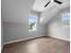 Bright bedroom features wood-look floors, a ceiling fan, and a window with lovely views at 1106 Celebration Ave, Celebration, FL 34747