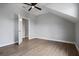 A neutrally decorated bedroom provides wood-look floors and an open door to another room at 1106 Celebration Ave, Celebration, FL 34747