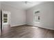 Bedroom featuring hardwood floors, white trim, large windows, and an ensuite bathroom for added comfort and convenience at 1106 Celebration Ave, Celebration, FL 34747