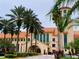 Exterior shot of a modern building with palm trees and manicured landscaping at 1106 Celebration Ave, Celebration, FL 34747