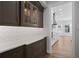 Butler pantry showcases stylish cabinetry, countertop space, and attractive backsplash design leading into a modern kitchen area at 1106 Celebration Ave, Celebration, FL 34747