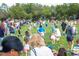are running around in a field collecting Easter eggs during an Easter egg hunt at 1106 Celebration Ave, Celebration, FL 34747