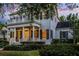 Charming two-story home featuring a welcoming front porch and balcony, complemented by lush landscaping and inviting curb appeal at 1106 Celebration Ave, Celebration, FL 34747