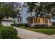 A two story home with an attached garage and lush landscaping lining the long driveway at 1106 Celebration Ave, Celebration, FL 34747